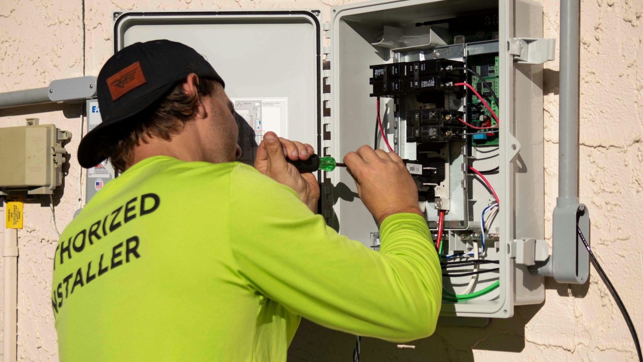 A licensed Houston electrician inspecting the interior of a residential electrical panel during a panel repair service call.