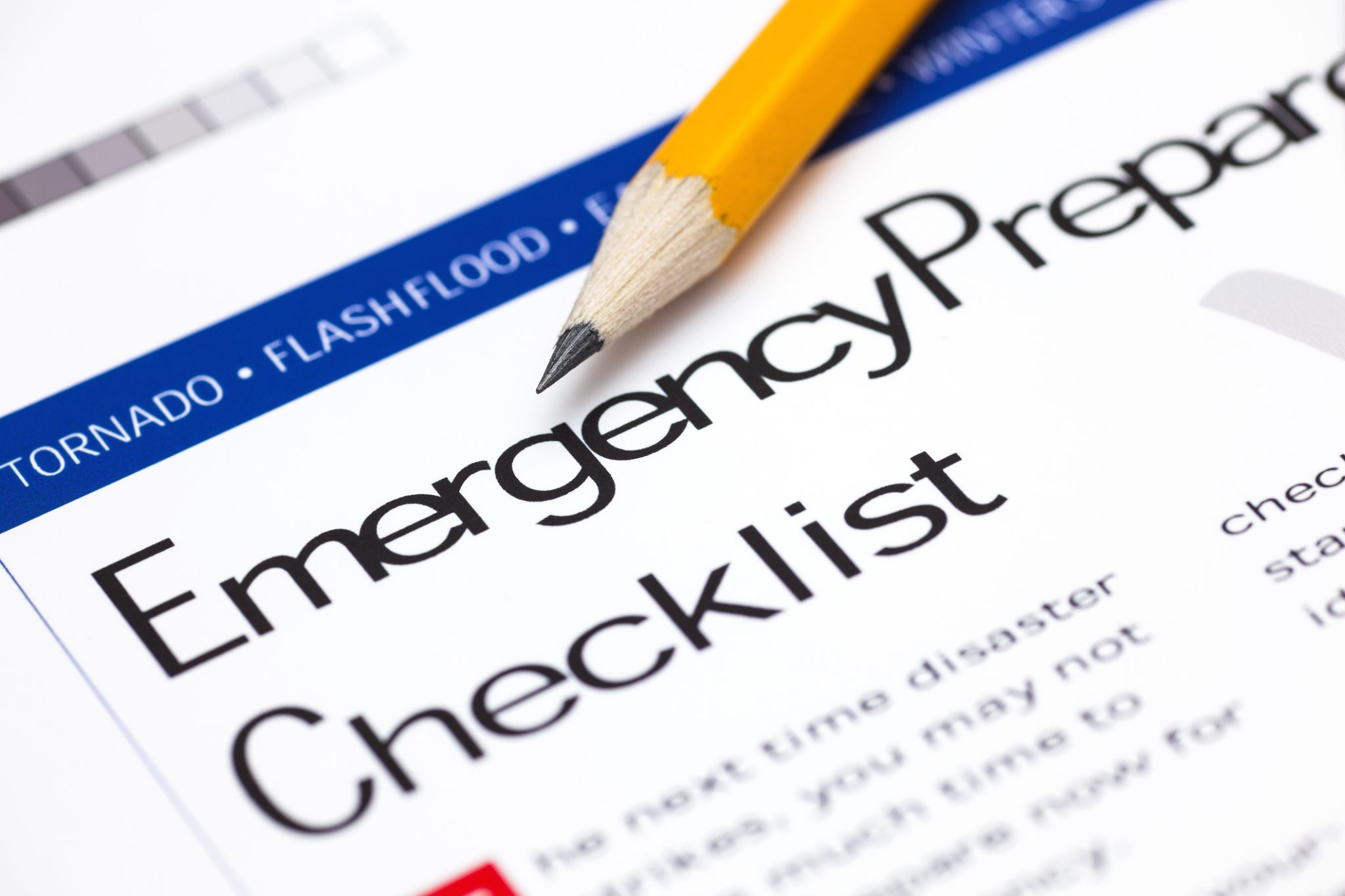 Pencil resting on an "Emergency Preparedness Checklist" document listing hazards that could be seen in Houston.